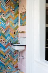 A colorful half bath was added in what was an old laundry porch. New siding was installed along the rear facing side of this wall as an ode to what was once the existing rear wall of the home.