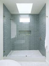 Heath Tile shower with marble hex tiles match the feel of the space. An awning window paired with a skylight let is needed natural lighting and fresh air.