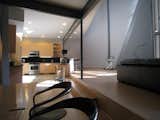 looking E: view from dining room into kitchen. horizontal grain rift oak mdf bd. w/ black granite countertops.  