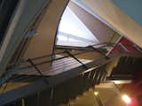 looking N from the lower level studio into the solar chimney: the window at the top naturally ventilates the house. a 2600 cfm mushroom exhaust fan (not seen) can also be used to assist. the undersides of the stair and furnishings needed to be detailed/finished since they are readily viewable.