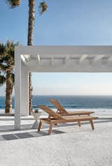 Outdoor, Stone Patio, Porch, Deck, and Trees The Solana teak lounger.  Photo 6 of 7 in Loungers by Gloster Furniture