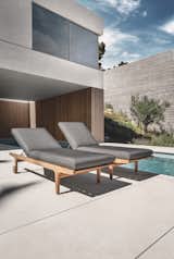 Outdoor, Trees, Large Pools, Tubs, Shower, Small Pools, Tubs, Shower, Back Yard, Swimming Pools, Tubs, Shower, Large Patio, Porch, Deck, Wood Patio, Porch, Deck, Concrete Patio, Porch, Deck, and Stone Patio, Porch, Deck The Bay lounger as part of a collection of lounge chairs, ottoman and sofas.  Photo 4 of 7 in Loungers by Gloster Furniture