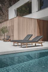 Outdoor, Back Yard, Hardscapes, Large Pools, Tubs, Shower, Small Pools, Tubs, Shower, Large Patio, Porch, Deck, Concrete Pools, Tubs, Shower, Swimming Pools, Tubs, Shower, Wood Patio, Porch, Deck, Concrete Patio, Porch, Deck, and Stone Patio, Porch, Deck The Bay lounger with all-weather fabrics in dark and bright colors.  Photo 5 of 7 in Loungers by Gloster Furniture