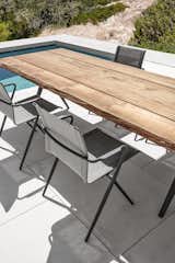 Chair, Table, Outdoor, Large Pools, Tubs, Shower, Small Pools, Tubs, Shower, Swimming Pools, Tubs, Shower, Large Patio, Porch, Deck, Hardscapes, Small Patio, Porch, Deck, Back Yard, and Tile Patio, Porch, Deck Stackable Ryder dining chair in a dark version in contrast to the limited edition teak table Split Raw.  Photo 13 of 22 in Dining Chairs by Gloster Furniture