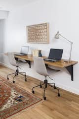 The family study features a 9 foot floating white oak desk with custom L-beam brackets by A. R. Lucas Construction.