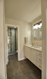 Bath Room, One Piece Toilet, Wall Lighting, Engineered Quartz Counter, Full Shower, Undermount Sink, Enclosed Shower, and Ceramic Tile Floor  Photo 7 of 9 in Cozy Condo at The Cloisters by BCC Construction