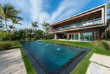 The home's modern exterior features glass, wood, and concrete.