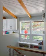 The stairwell brightens up with new openings to the kitchen and enlarged windows to the backyard.
