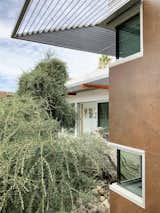 Steel sunshades and corten-inspired wall tile.
