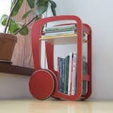 red small book shelf with wheels.