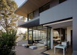 Outdoor, Concrete Patio, Porch, Deck, Shrubs, Hardscapes, Trees, Metal Patio, Porch, Deck, Wood Patio, Porch, Deck, Walkways, Side Yard, and Large Patio, Porch, Deck Exterior into Kitchen and Living Room   Photo 16 of 33 in Dolores Heights Residence I by John Maniscalco Architecture