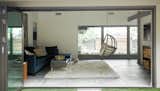 NanaWall bifold glass doors open to the living room and den, allowing views from the back lawn to the front courtyard.