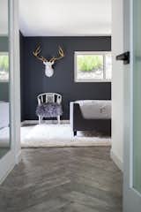 Bedroom, Chair, Bed, Recessed, and Porcelain Tile A gold-antlered ceramic deer head hangs above a flea market Chinoiserie chair in the master bedroom.  Bedroom Chair Recessed Porcelain Tile Photos from Diablo Ranch