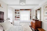 Bedroom, Dresser, Night Stands, Bench, Bookcase, Ceiling Lighting, Medium Hardwood Floor, and Bed  Photo 6 of 7 in UNCOVERING A 1929 UPPER EAST SIDE GEM (Sweeten project) by Pixy Interiors