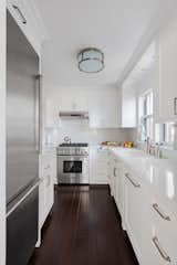 Kitchen, Dark Hardwood Floor, Refrigerator, Drop In Sink, Wall Oven, and White Cabinet  Photo 14 of 19 in Kitchen by Pixy Interiors from AN ART-FILLED APARTMENT RENOVATION 40 YEARS IN THE MAKING!