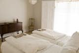 Bedroom, Bed, Dresser, Chair, Pendant Lighting, and Light Hardwood Floor heirloom mahogany chest; vintage painted chair; Baby & Child linen chandelier to complement linen bedding and towels  Photos from PILGRIM HOUSE