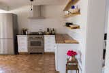 Bertazzoni stove, ranch shelves, mid-century side table, Daltile Florentine Carrara porcelain backsplash