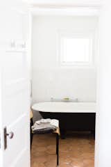Footed tub, the base of which is painted Railings by Farrow & Ball; Smedbo Air towel hooks in foreground