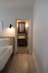 view into master bath; custom vanity; heirloom mirror; light pine floors