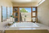 The master bath a spa retreat include a jetted oversized tub and the ceiling faucet which fill the bathtub.
