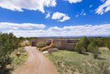 The contemporary High Desert residence is at the end of a cul-de-sac which backs up to a greenbelt offering privacy and stunning views of the Santa Fe mountains.