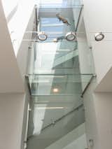 Glass enclosed staircase with glass bridges on each floor