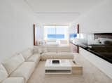 White travertine floors, neutral furnishings, and soft wood tones allow the emphasis to lie with nature, the view, and the sensory experience of being on the ocean.&nbsp;