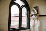 The original dark wood window frames and exterior brick walls remain intact. Simple, modern additions provide amenities in the guest rooms.