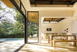 Large, operable glass doors and clerestory windows provide a fluid transition between the interior retreat and the exterior landscape.
