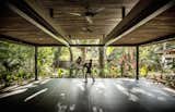 The yoga studio is surrounded on all sides by the jungle.  Light, shadows, and wind pass through the open structure.