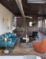 Living Room, Coffee Tables, Chair, Sofa, End Tables, Concrete Floor, Table Lighting, Rug Floor, Ceiling Lighting, Medium Hardwood Floor, and Lamps  Photo 5 of 11 in History and Modernity Meet in This Industrial Hotel and Restaurant in Philadelphia