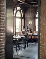 Dining Room, Chair, Table, Bench, Pendant Lighting, and Wall Lighting Simple pendant lighting, succulent greenery, and leather booths are simple, thoughtful elements that decorate the chic eatery.&nbsp;