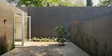 Side Yard, Hardscapes, Doors, Trees, Flowers, Metal, Sliding Door Type, Folding Door Type, and Exterior  Photo 9 of 11 in Delightful Material Contrasts Define a Courtyard Home in Mexico City