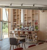 Dining, Chair, Stools, Bar, Shelves, Storage, Pendant, Track, Table, and Concrete  Dining Pendant Storage Track Photos from Harmonizing With Nature, These Eco-Huts Offer Respite in the Heart of France