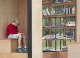 Guests are invited to bring and take books, or lounge on the built in seating while reading.  Photo 5 of 8 in Toronto's Story Pod Doubles as a Lending Library and Community Hub