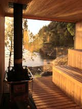 Encased with wood and glass, and surrounded by trees and rocks, the sauna is a meditative hideaway with private lakefront views.&nbsp;