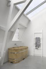 A traditional Japanese-style bathtub, custom-ordered through Bartok Design, sits elegantly in one of the baths.