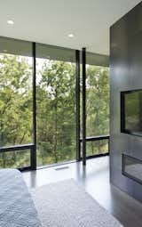 Windows, Picture Window Type, and Metal The master suite is filled with plentiful views, while taking advantage of the forest of cedars to provide complete privacy year round.  Photos from An Incredible Forest Home Leaps Over a Ravine