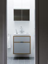 A floating bath vanity is composed of the same plywood detailing.&nbsp;