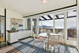 Dining Room, Ceiling Lighting, Rug Floor, Chair, and Table Full height glass doors allow the viewing terrace to blend seamlessly into the interior breakfast nook.  Photo 7 of 14 in A Bay Area Jewel With Golden Gate Views Wants $1.55M