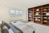 Bedroom, Bed, Shelves, Recessed Lighting, and Carpet Floor Built in bookshelves frame the Master Bedroom.  Photos from A Bay Area Jewel With Golden Gate Views Wants $1.55M