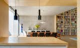 Simple Alvar Aalto pendants hang below the wooden ceiling in the kitchen.