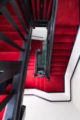 The Victorian stairwell at Roam London is lush and luxurious, with bold red treads and risers.&nbsp;