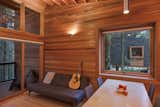 Dining Room, Chair, Pendant Lighting, Medium Hardwood Floor, Table, and Wall Lighting  Photo 8 of 8 in Camp in Style at This Trio of Cedar-Clad Cabins in Minnesota