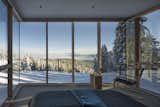 Bedroom, Carpet Floor, Bed, Chair, and Recessed Lighting Surrounded by glazing on three sides, the Master is a suite above the slopes, surrounded by nature.  Photo 15 of 48 in Vacation Home - Winter by Neiva Desrochers from These Contemporary Lake Tahoe Chalets Have Ski-In, Ski-Out Access