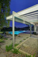 Outdoor, Walkways, Gardens, Side Yard, Swimming, Shrubs, Trees, Hardscapes, and Large Exposed structural members reach outwards and are painted a silver hue.   Outdoor Side Yard Walkways Swimming Hardscapes Large Photos from Richard Neutra’s Boxcar-Style Loring House Lists for $8M in the Hollywood Hills