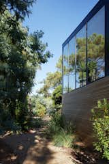 Minimal materials allow the dwelling to blend kindly into the surroundings, while large amounts of glazing increases the connection between the structure's built form and nature. 