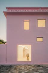 Exterior, Flat RoofLine, House Building Type, and Stucco Siding Material Large windows connect occupants to the exterior courtyard and surroundings.   Photo 11 of 17 in These Pink and Blue Homes Use Gender as a Metaphor For Urban Revitalization