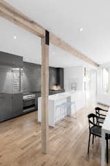 The original load bearing wall was replaced with a wood beam and vertical supports, creating a more open floor plan. 
