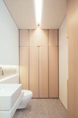 Bath Room, One Piece Toilet, Accent Lighting, and Vessel Sink The powder room ceilings are designed to resemble abstract cloud formations.  Beautiful wood joinery provides ample storage.  Photos from A Steel Staircase Merges Two Units Into One in Tribeca